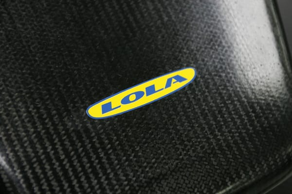 Logo of he Lola Cars company on carbon fibre